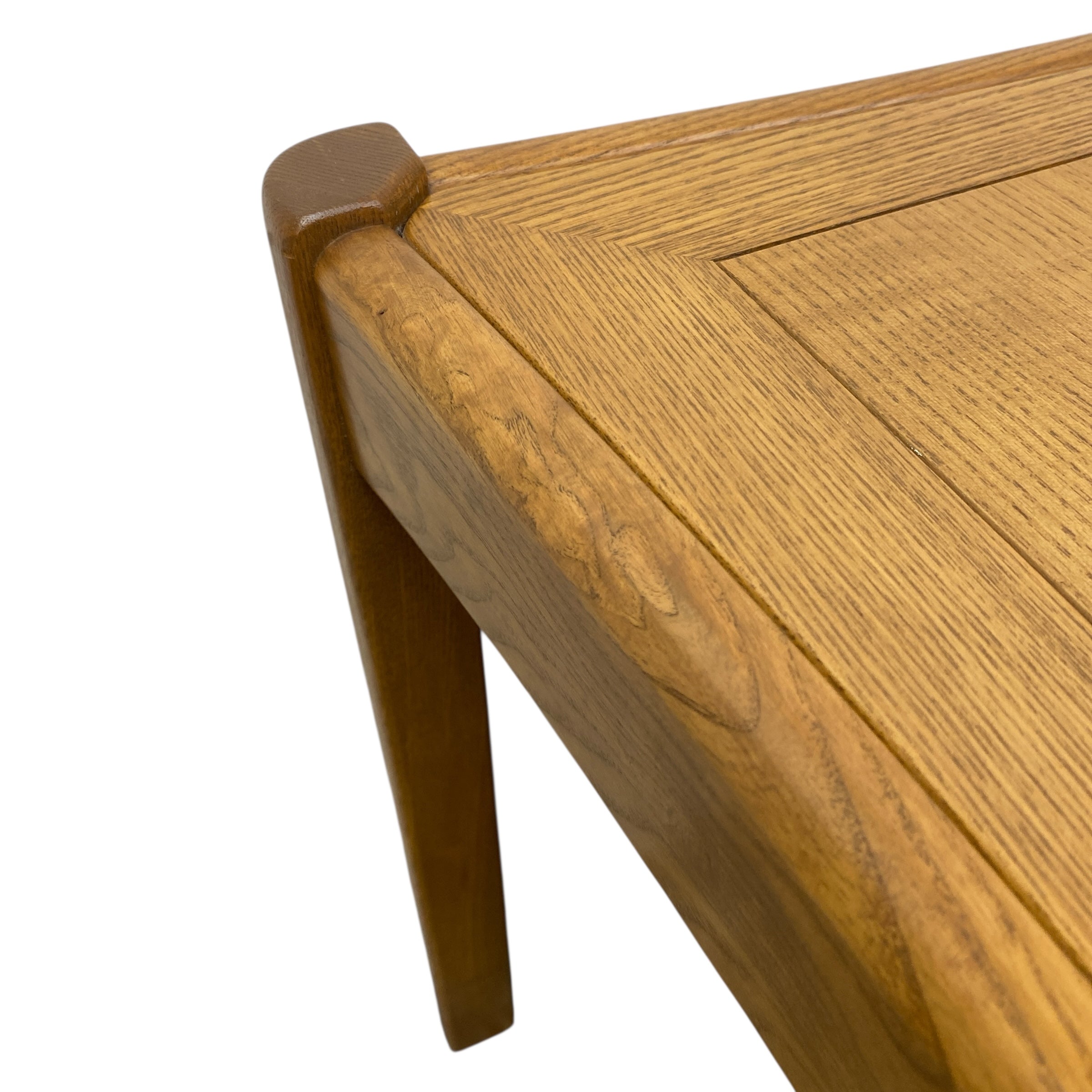 Close-up of a wooden table corner with a white background