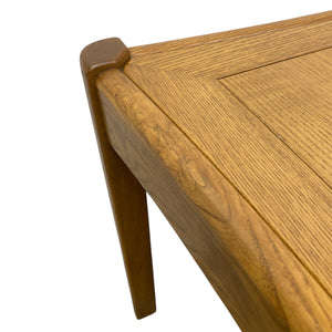 Close-up of a wooden table corner with a white background