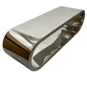 Metallic coffee table with reflective surface on a white background