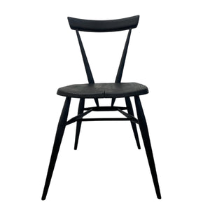 Black wooden chair with woven seat on a white background