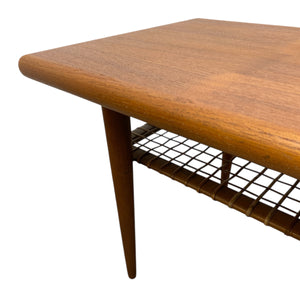 teak coffee table and cane magazine rack
