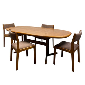 Wooden dining table with four matching chairs on a white background