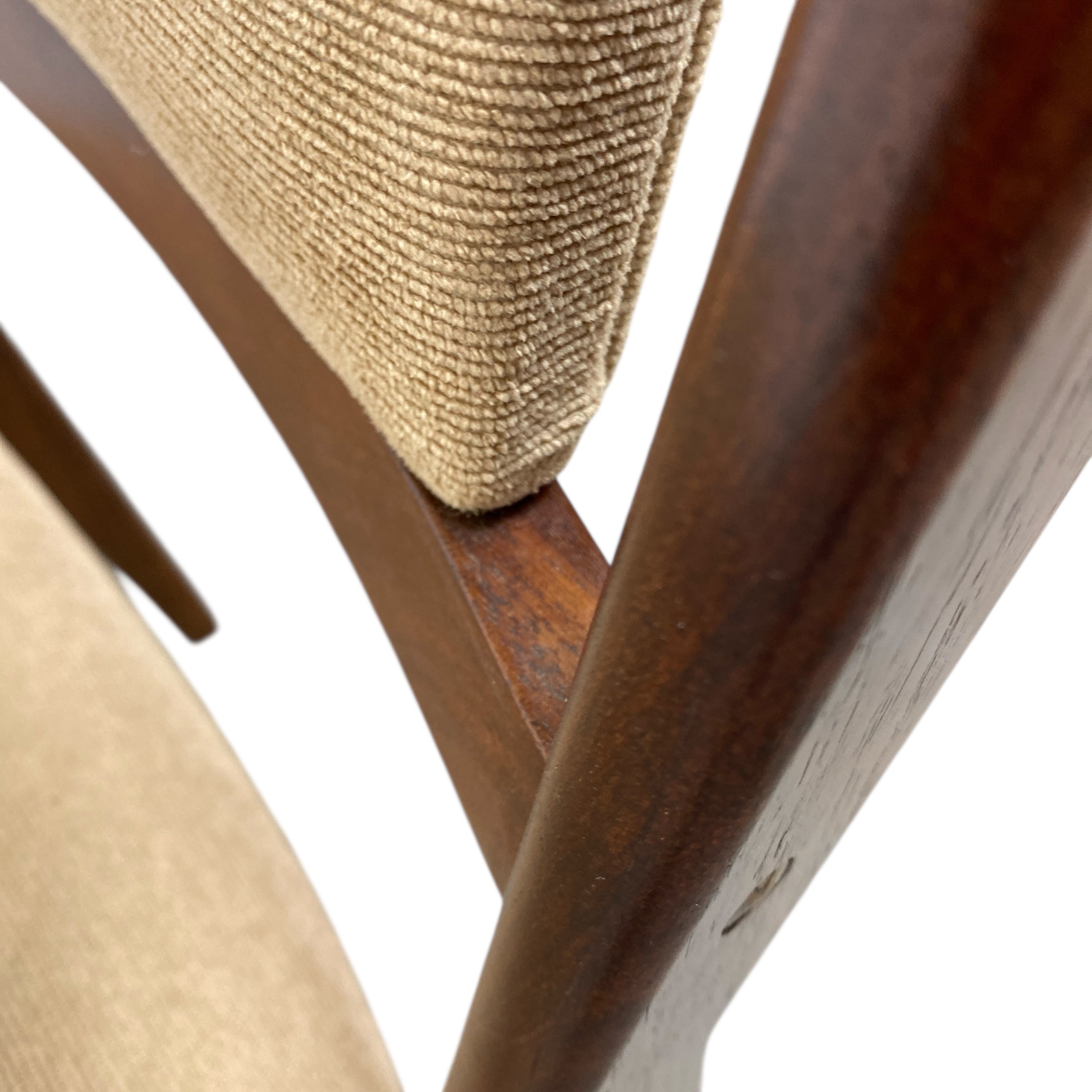 Close-up of a wooden chair with woven seat on a white background