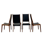 Load image into Gallery viewer, Four wooden chairs with black leather seats on a white background
