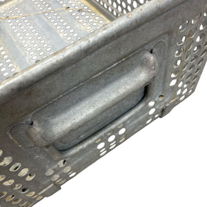 Metallic grill basket with handle on a white background