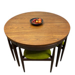 Load image into Gallery viewer, Round wooden dining table with four chairs on a white background
