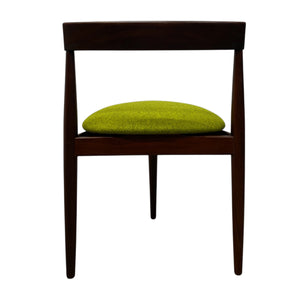 Wooden chair with a green cushion on a white background