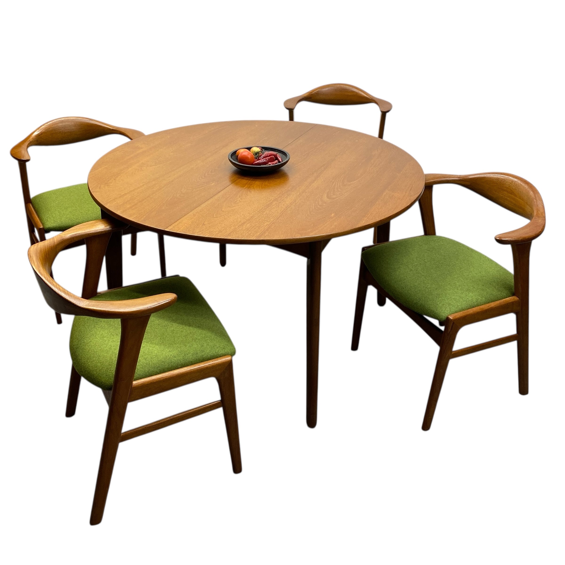Round wooden table with four matching chairs on a white background