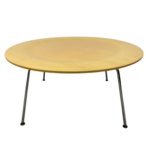 Round wooden table with metal legs on a white background