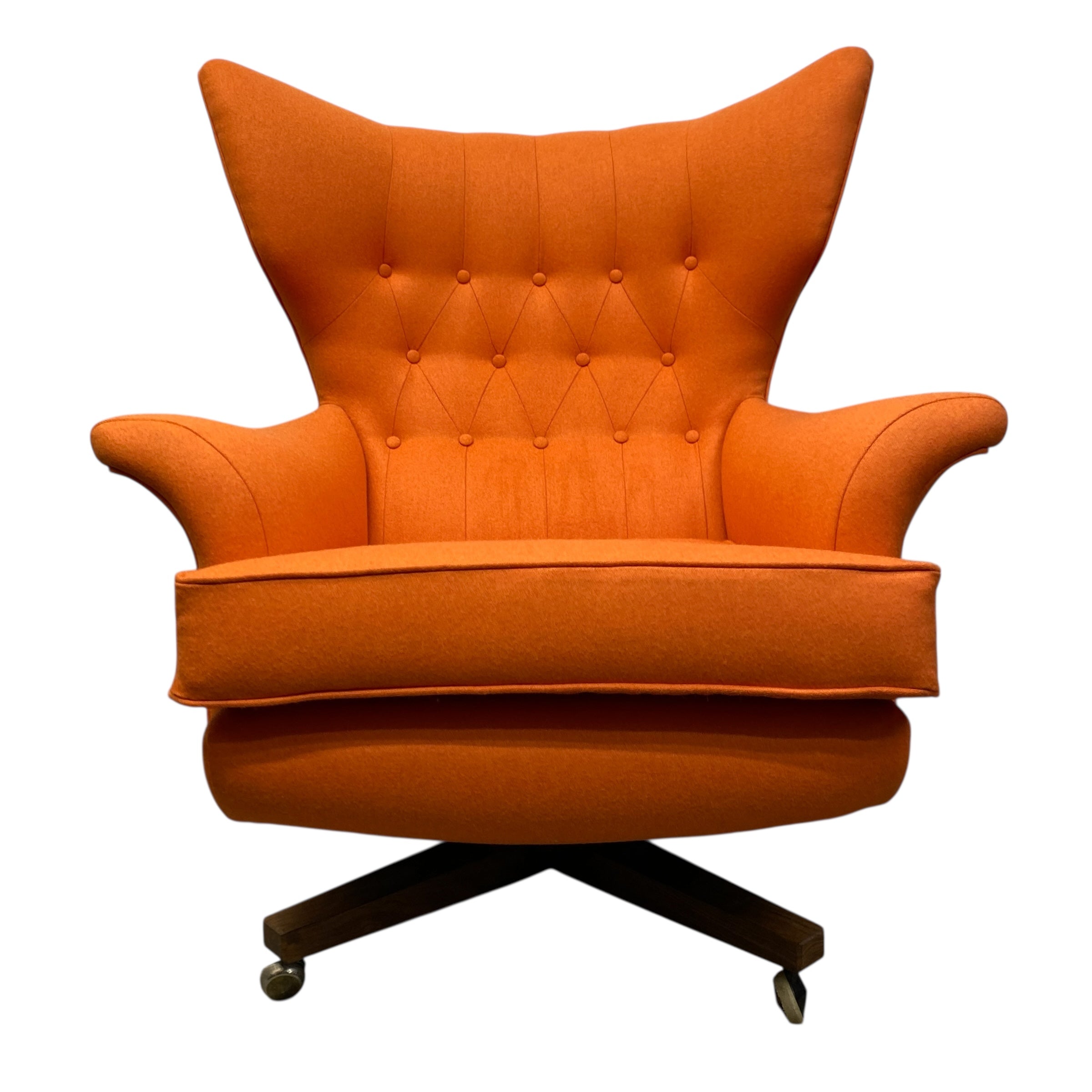 Orange armchair with tufted backrest on a white background