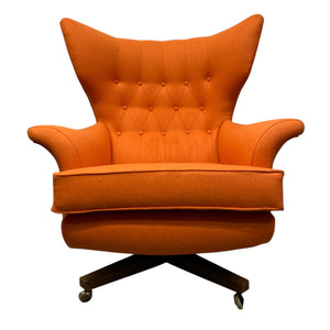 Orange armchair with tufted backrest on a white background