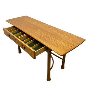 Wooden desk with a drawer on a white background