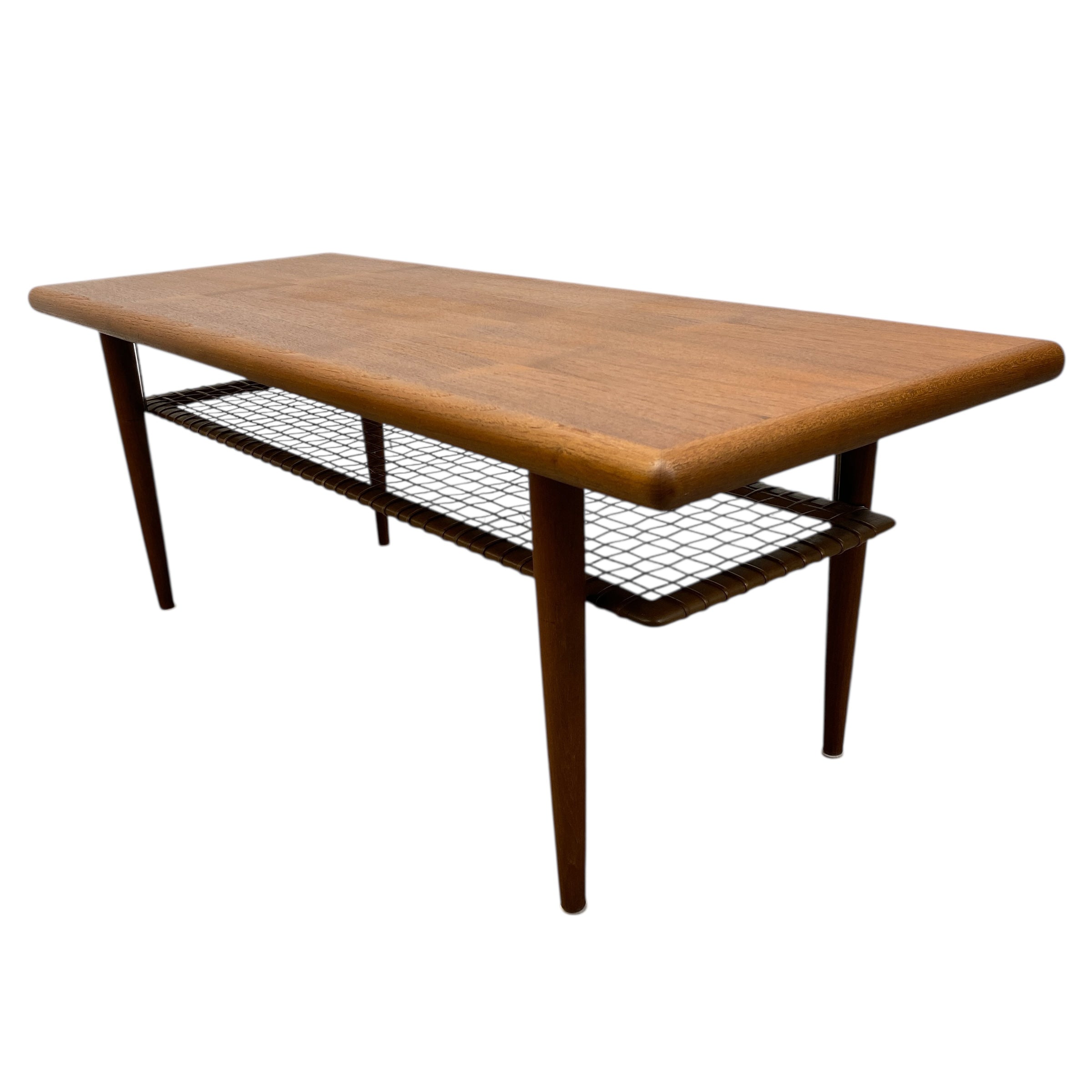 Wooden coffee table with magazine shelf on a white background