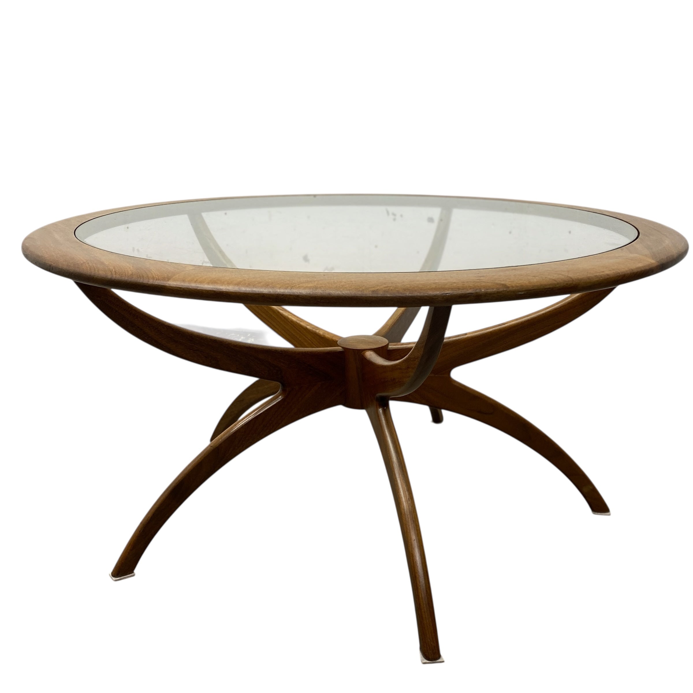 Round wooden table with glass top on a white background