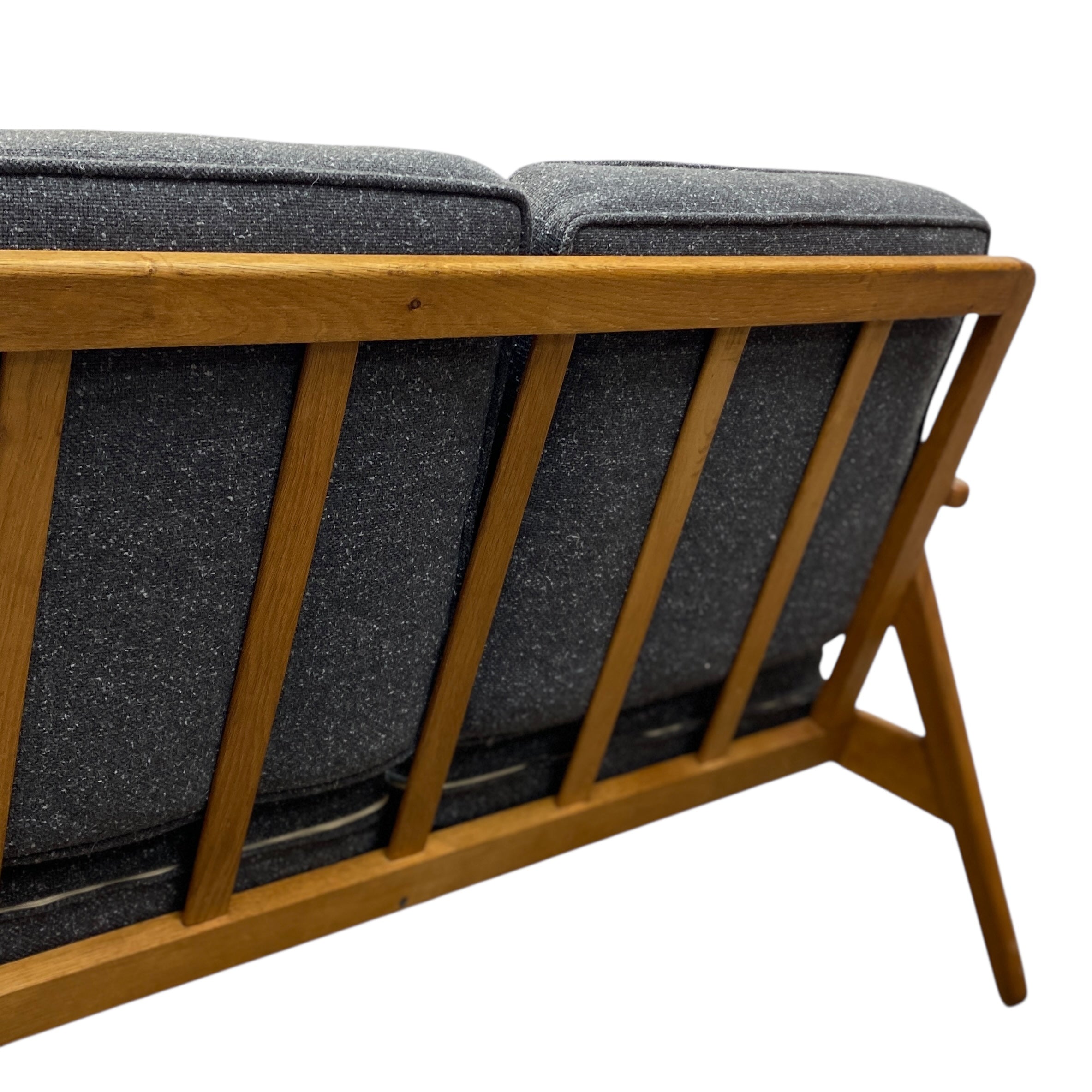 Sofa with wooden frame and grey cushions on a white background