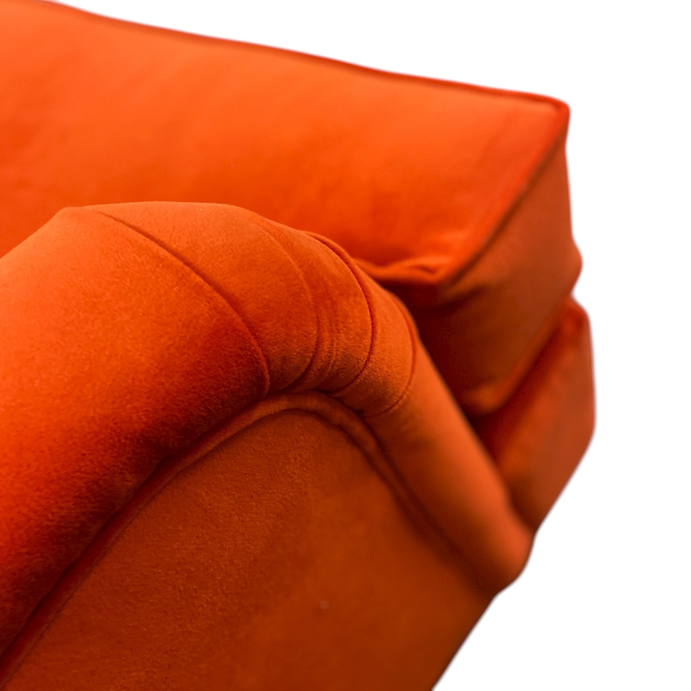 Close-up of an orange cushion with a soft texture on a white background