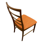 Load image into Gallery viewer, Wooden chair with an orange cushion on a white background
