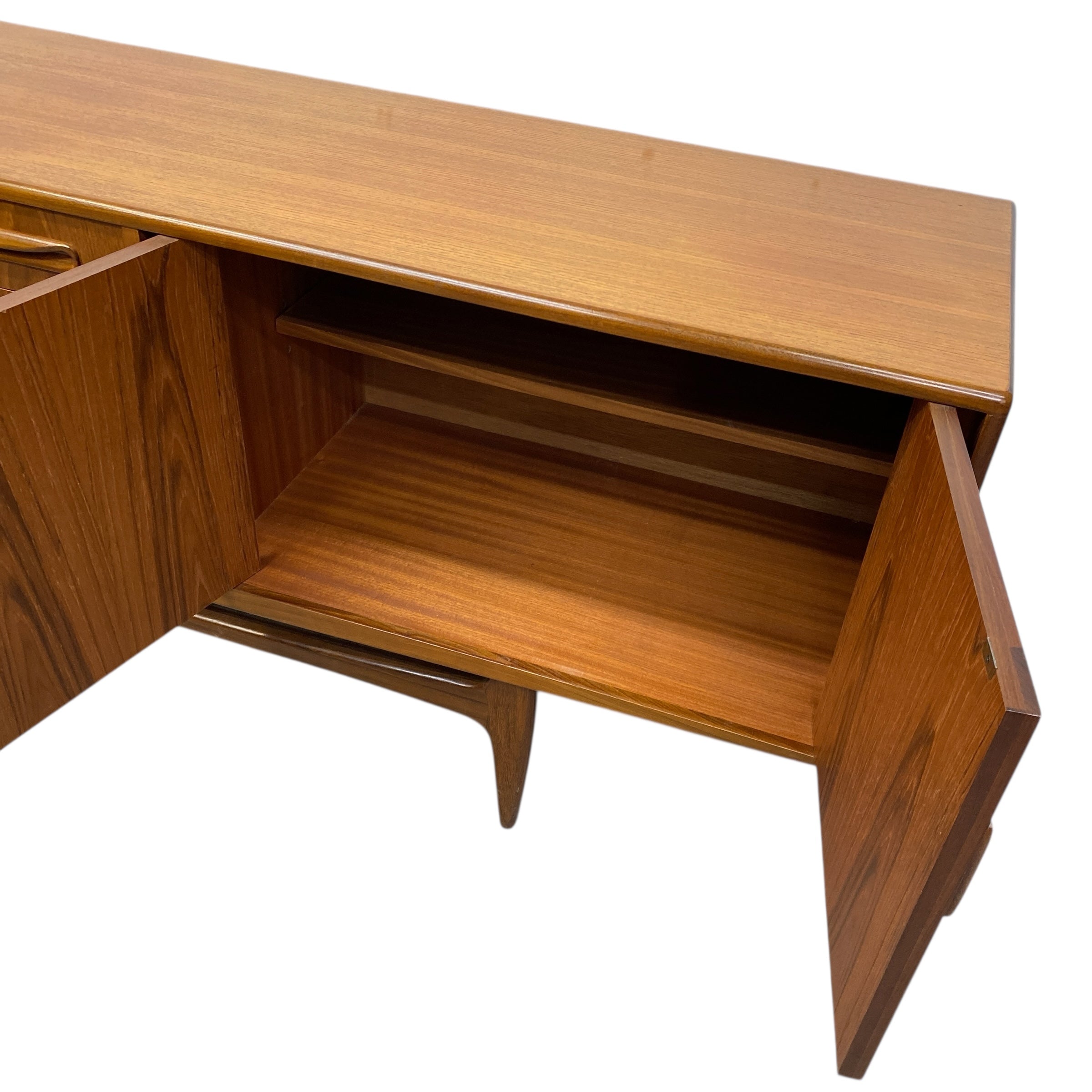 G Plan Wooden sideboard with open cabinet on a white background