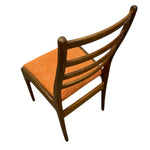 Load image into Gallery viewer, Wooden chair with orange cushion on a white background

