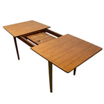 Load image into Gallery viewer, Wooden dining table with two extendable leaves on a white background
