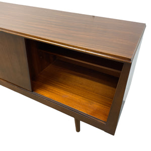 Wooden sideboard with a single door on a white background