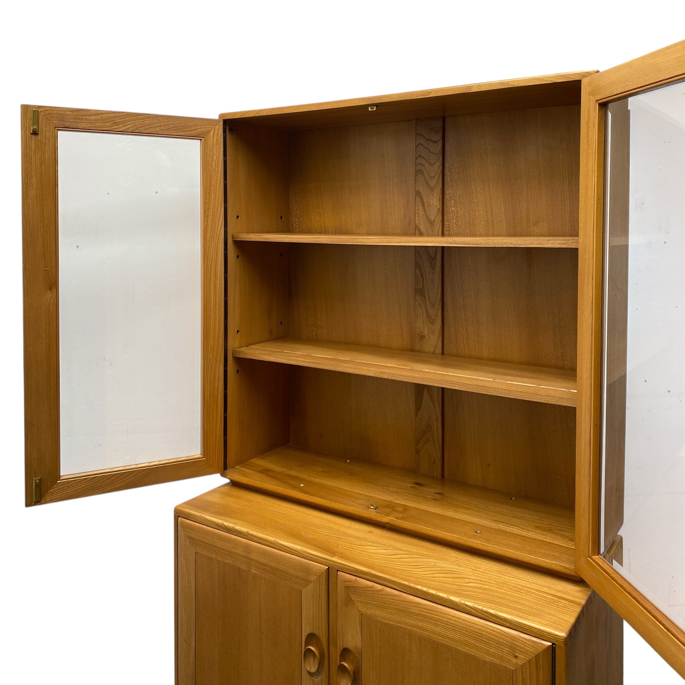 Wooden cabinet with glass doors on a white background