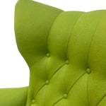 Load image into Gallery viewer, Close-up of a green upholstered chair with tufted backrest on a white background
