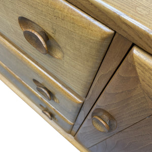 Close-up of a wooden drawer with handles on a white background