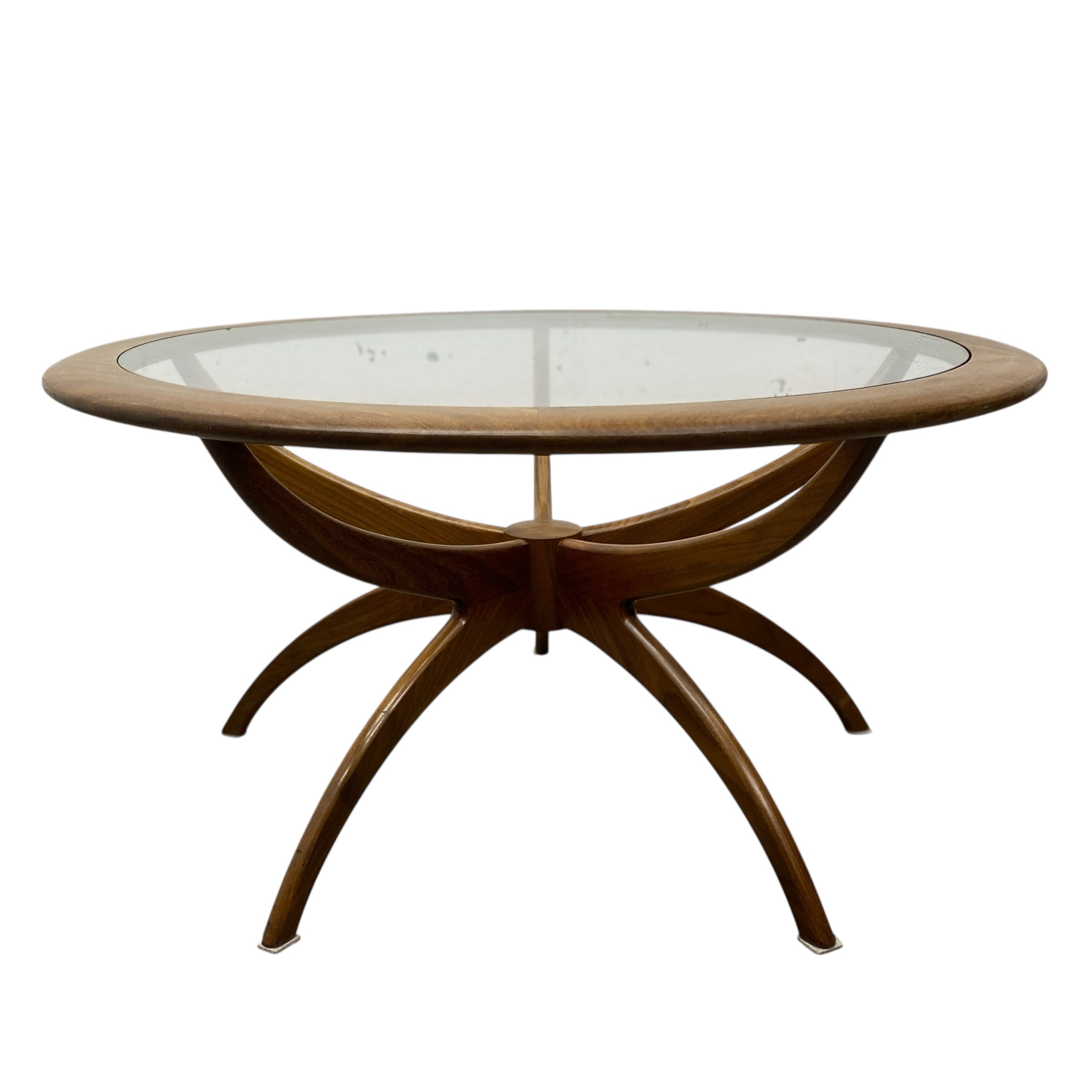 Round wooden table with glass top on a white background