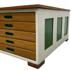 Wooden drawer unit with green panels on a white background