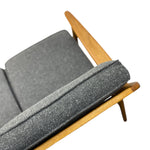 Load image into Gallery viewer, Sofa with grey cushions and wooden frame on a white background
