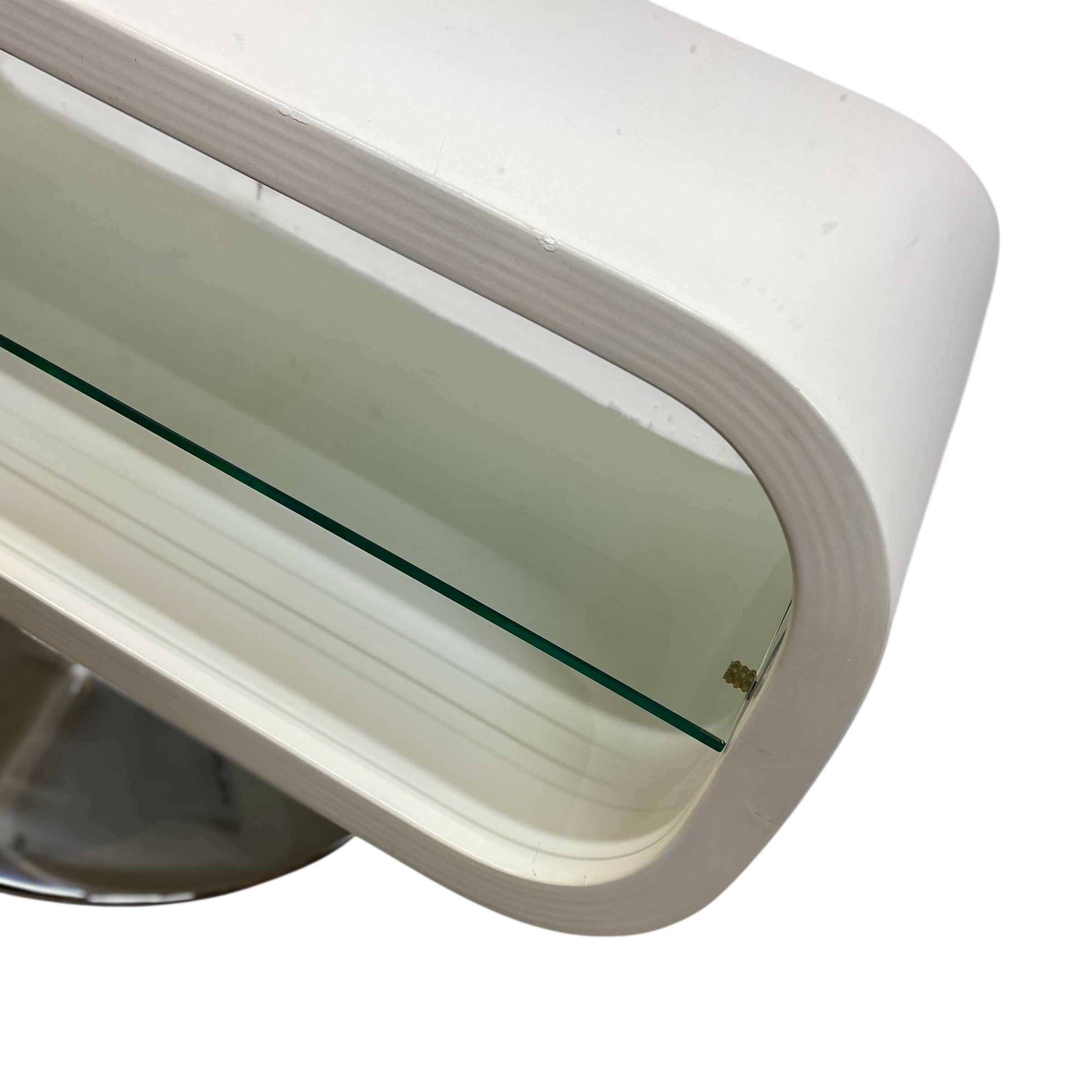 Close-up of a white plastic component with a glass insert on a white background