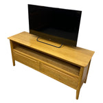Load image into Gallery viewer, Wooden TV stand with a television on top against a white background
