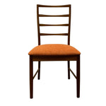 Load image into Gallery viewer, Chair with wooden frame and orange cushion on a white background
