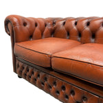 Load image into Gallery viewer, Reddish Brown leather sofa with tufted backrest on a white background
