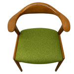 Load image into Gallery viewer, Chair with wooden armrests and green cushion on a white background
