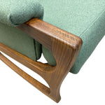 Load image into Gallery viewer, Close-up of a green upholstered chair with wooden armrests on a white background
