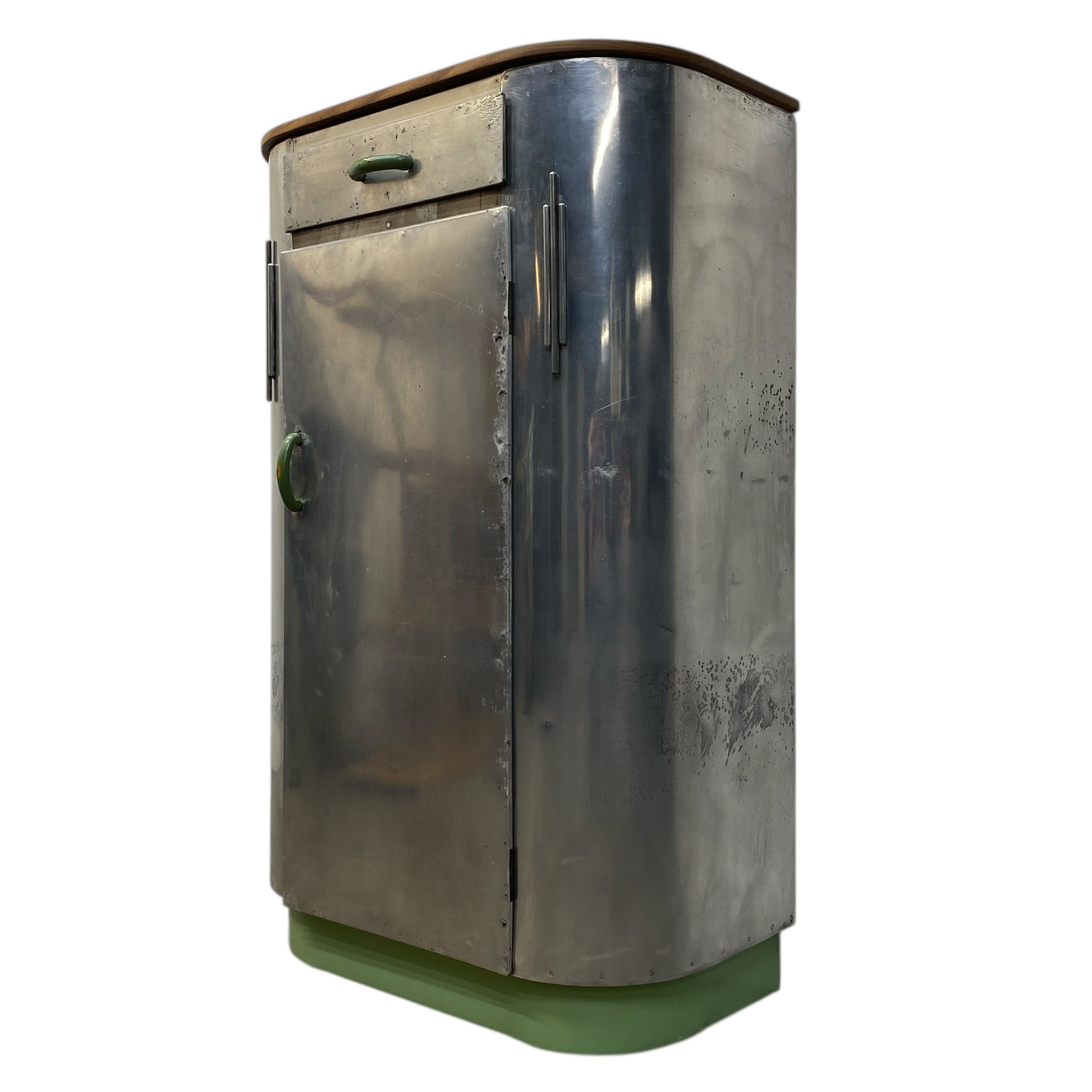 Metallic cylindrical object with a green base on a white background