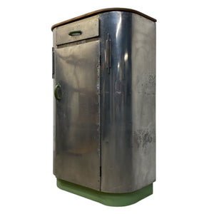 Metallic cylindrical object with a green base on a white background