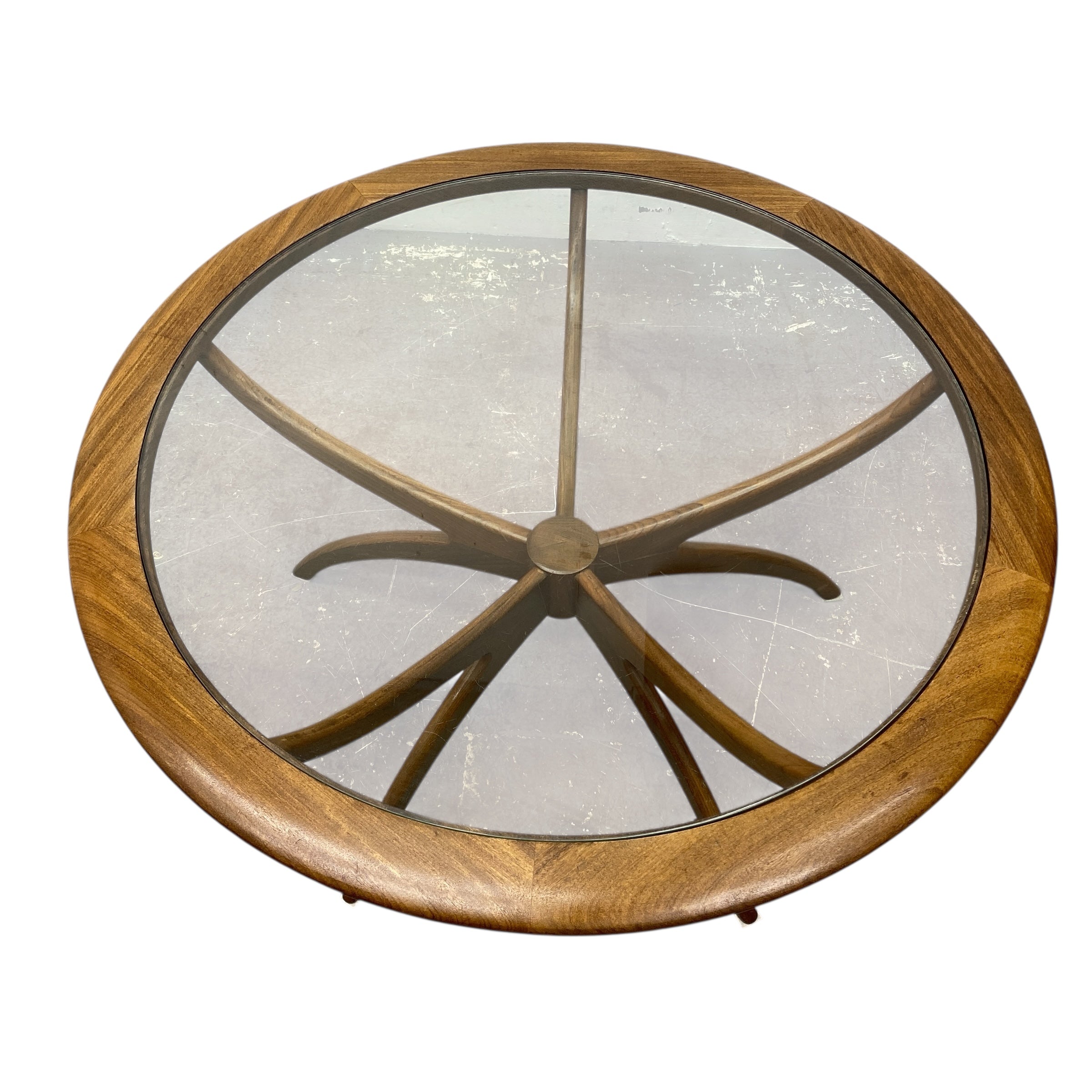 Round wooden table with glass top on a white background