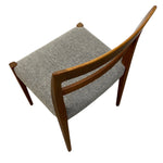 Load image into Gallery viewer, Wooden chair with a textured gray cushion on a white background
