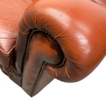 Load image into Gallery viewer, Close-up of a reddish brown leather boxing glove on a white background

