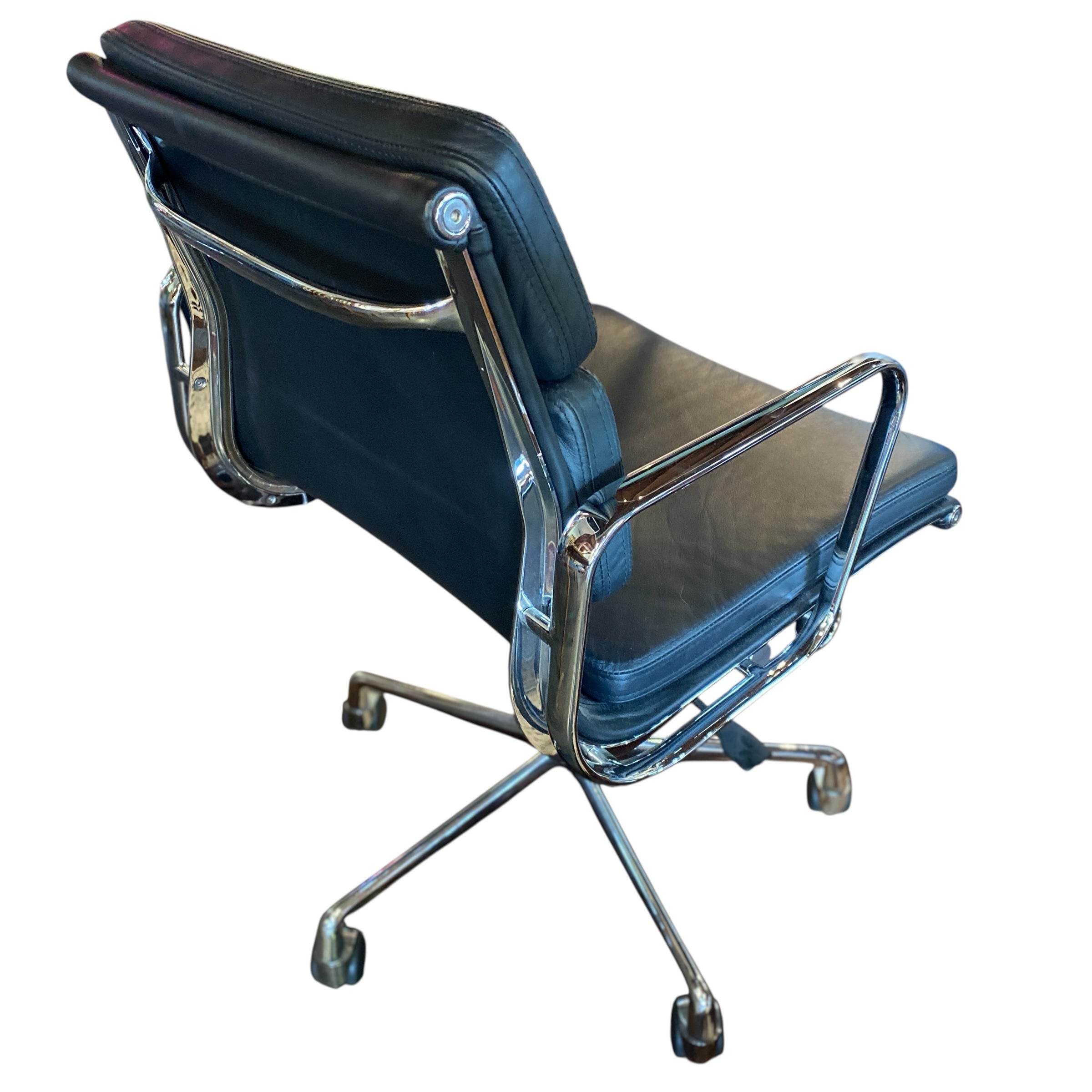 Diagonal profile of chair highlighting arm rest detail and polished chrome