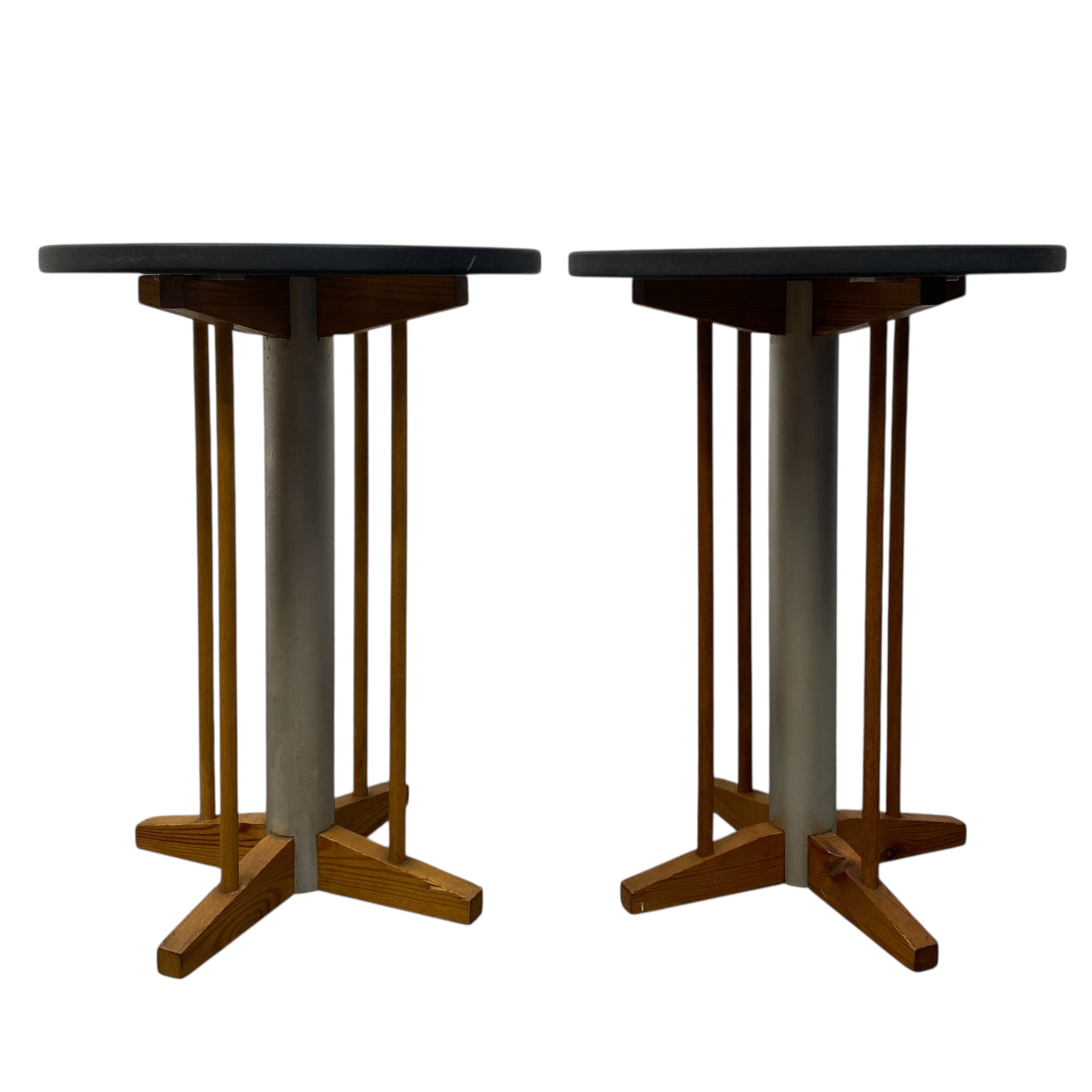 Two wooden tables with black tops on a white background