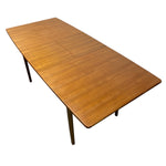 Load image into Gallery viewer, Wooden dining table with a single extension leaf on a white background
