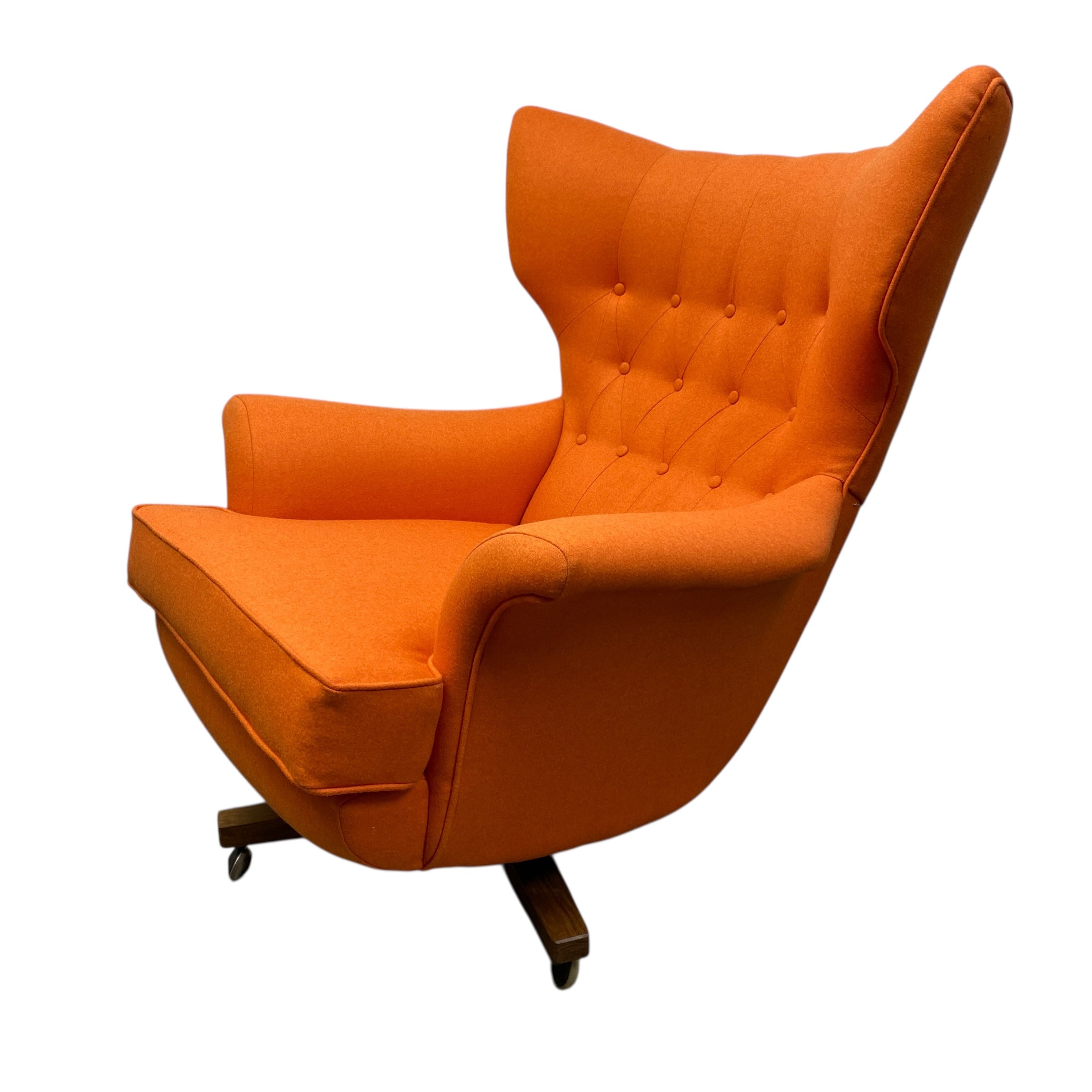 Orange wingback chair on a white background