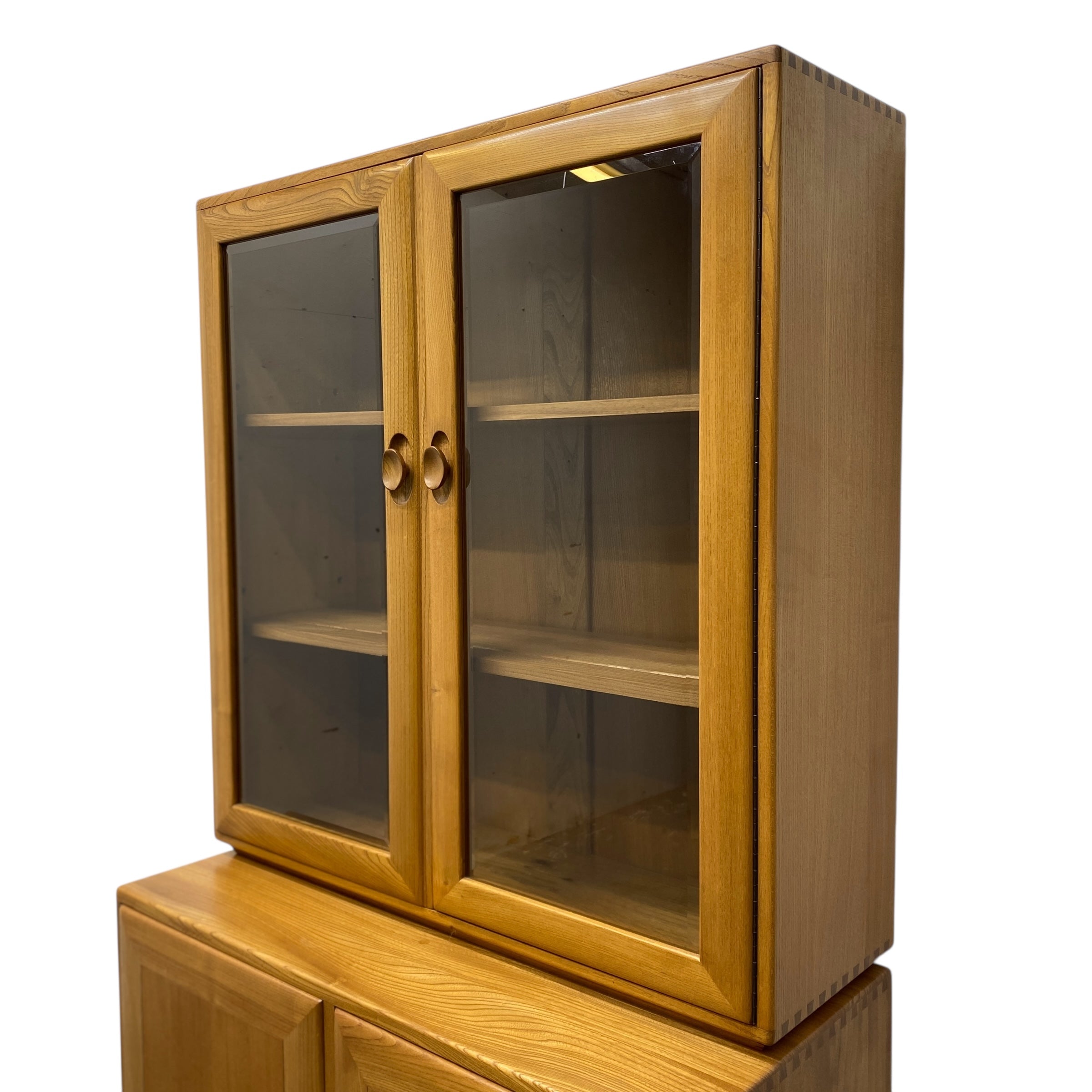 Wooden cabinet with glass doors on a white background