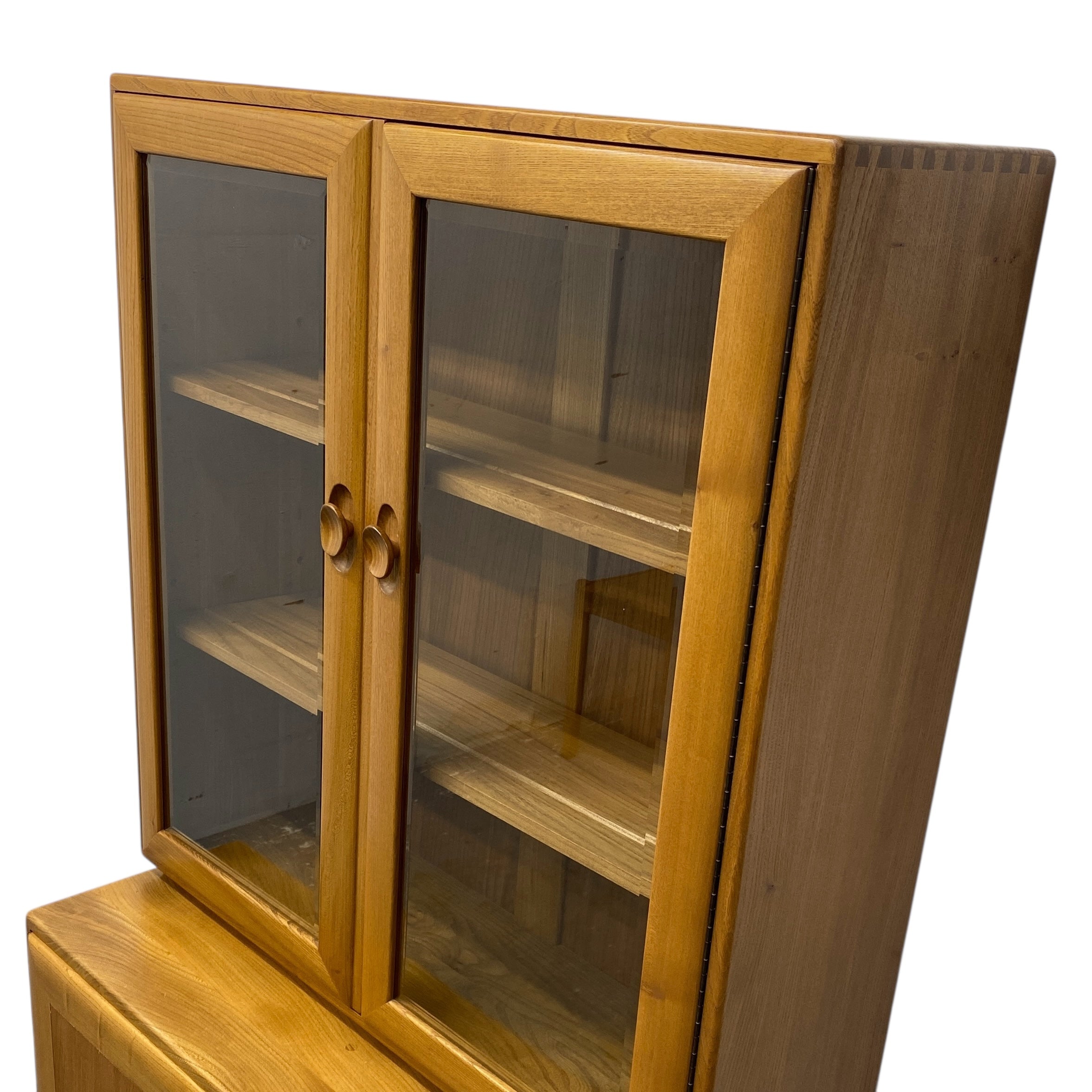 Wooden cabinet with glass doors on a white background