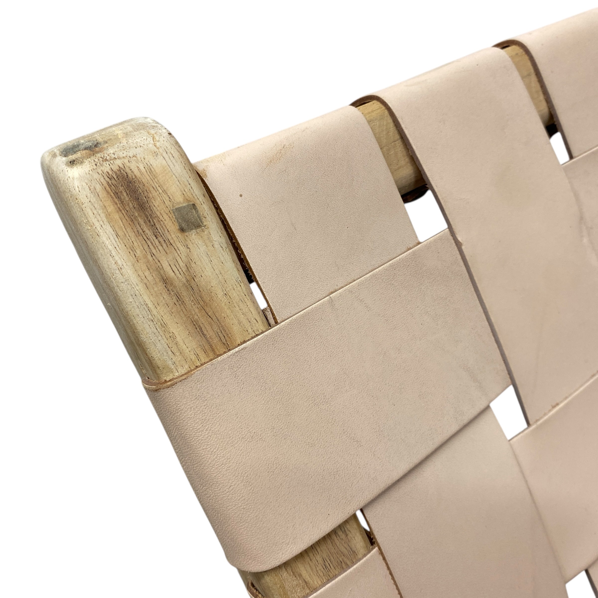 Close-up of a woven chair with wooden and fabric elements on a white background