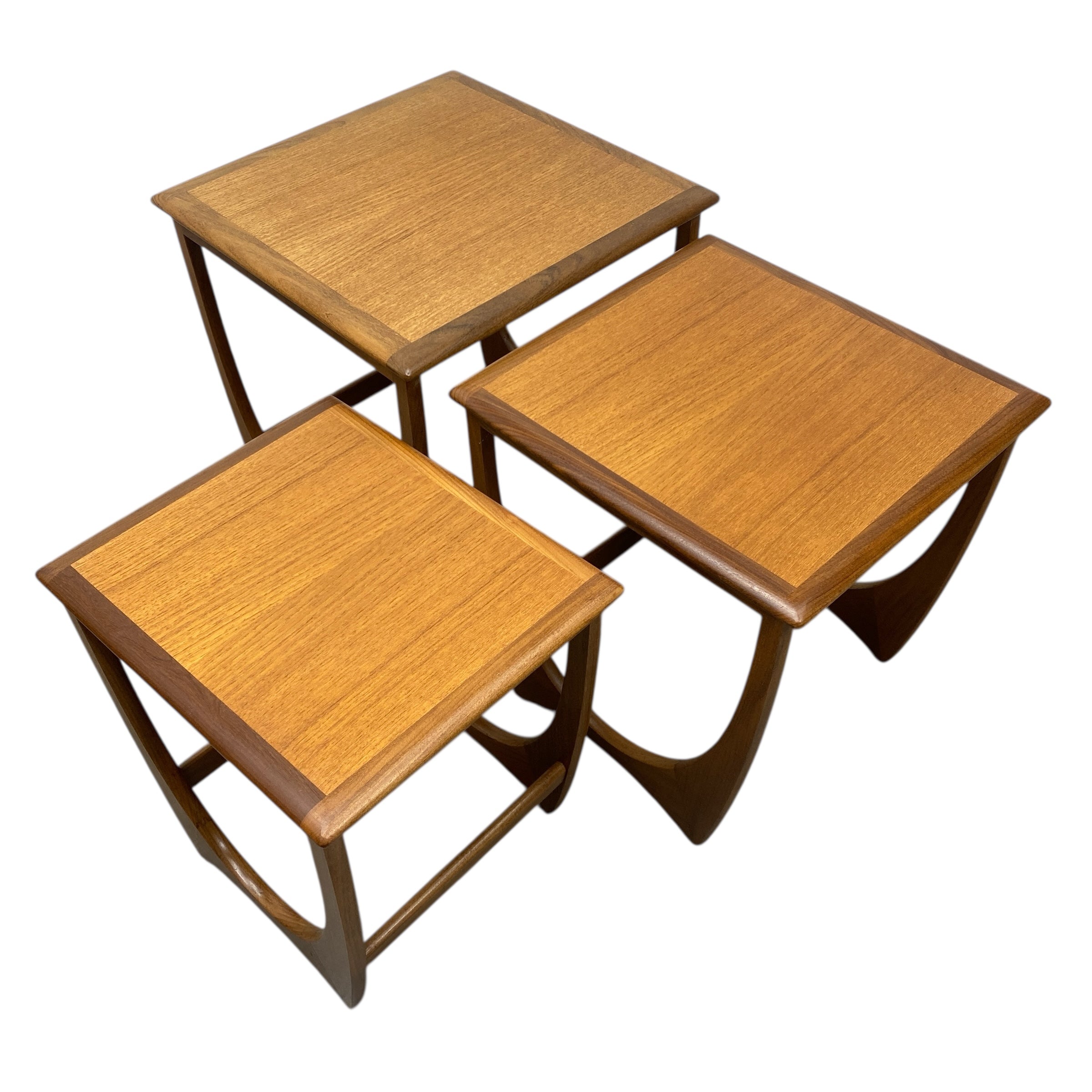 Set of three wooden nesting tables on a white background
